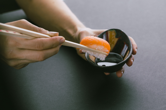 Sushi dunking in sauce